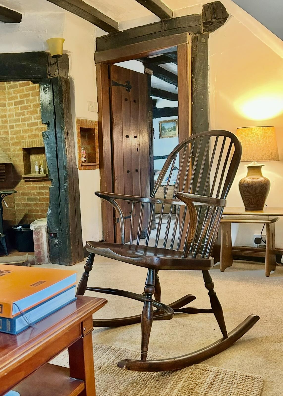 Antique Windsor rocking chair beside the inglenook